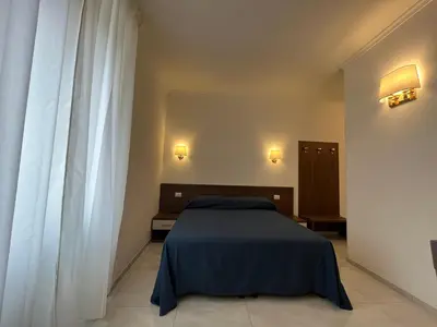 a bedroom with a blue bed and a window at Giovanni Guest House in Rome