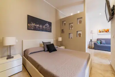a bedroom with a bed and a blue couch at GuestHost - Bright Apartment near Villa Borghese in Rome