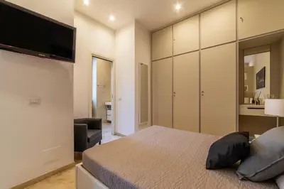 a bedroom with a bed and a flat screen tv at GuestHost - Bright Apartment near Villa Borghese in Rome