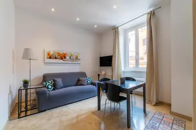 a living room with a couch and a table at GuestHost - Bright Apartment near Villa Borghese in Rome