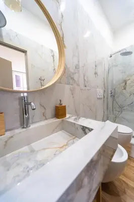 a bathroom with a tub and a sink and a mirror at Casa Cattaneo, a due passi da Santa Maria Maggiore in Rome