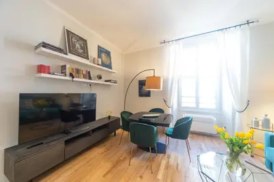a living room with a table and a large television at Casa Cattaneo, a due passi da Santa Maria Maggiore in Rome