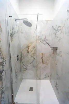a bathroom with a shower with a glass door at Casa Cattaneo, a due passi da Santa Maria Maggiore in Rome