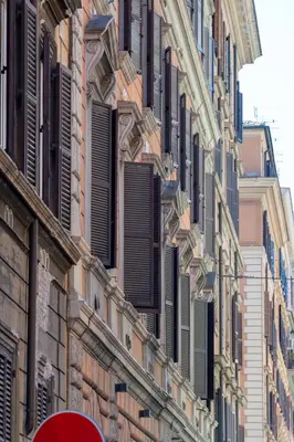 a building with shutters on the side of it at Casa Cattaneo, a due passi da Santa Maria Maggiore in Rome