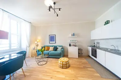a kitchen and living room with a blue couch at Casa Cattaneo, a due passi da Santa Maria Maggiore in Rome