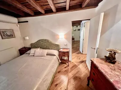 a bedroom with a bed and a wooden floor at Torre della Scimmia apartment in Rome
