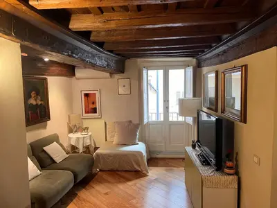 a living room with a couch and a bed and a window at Torre della Scimmia apartment in Rome