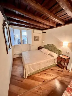 a bedroom with a large bed and a window at Torre della Scimmia apartment in Rome