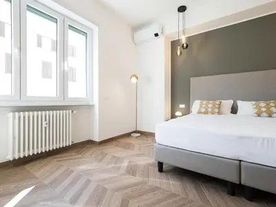 a bedroom with a white bed and a window at Savoia Rooms Roma in Rome