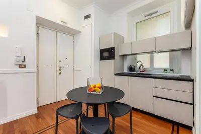 a kitchen with a table with a bowl of fruit on it at Aletheia Èlite - Elegant 2 BR in Rome