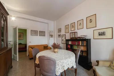 a living room with a table with chairs and a couch at GuestHost - San Giovanni in Laterano Comfy Apartment in Rome