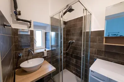 a bathroom with a sink and a shower at La Pietra al Pigneto in Rome
