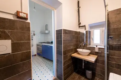 a small bathroom with a sink and a shower at La Pietra al Pigneto in Rome