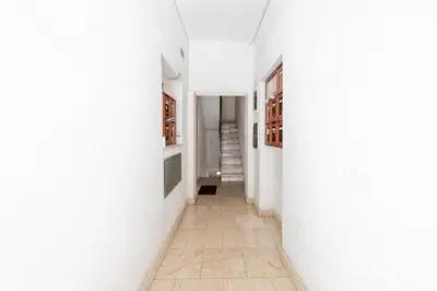 an empty hallway with white walls and a tile floor at La Pietra al Pigneto in Rome