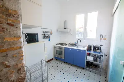 a small kitchen with a sink and a stove at La Pietra al Pigneto in Rome