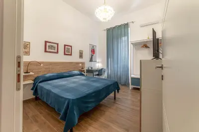 a bedroom with a bed and a television in a room at Casa Marin - Metro Malatesta in Rome