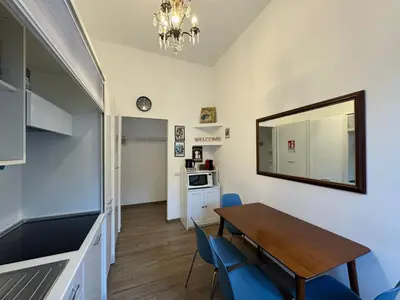 a dining room with a table and chairs and a mirror at Casa Marin - Metro Malatesta in Rome