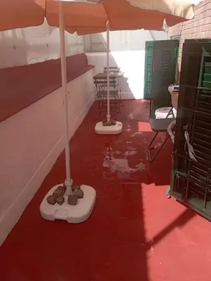 two umbrellas on a red floor in a room at Pigneto House in Rome