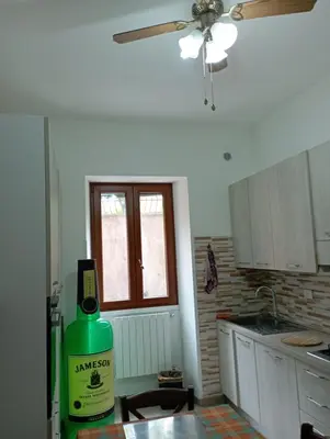 a kitchen with a bottle of wine on a table at Pigneto House in Rome