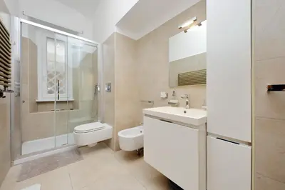a bathroom with a toilet sink and a shower at suity I cozy anglona apartment in Rome