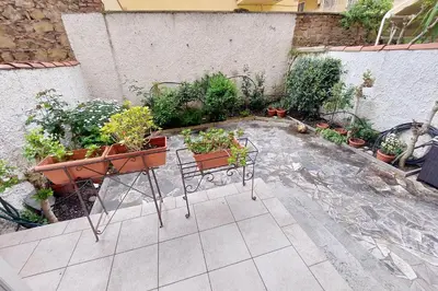 a patio with a bunch of potted plants on it at suity I cozy anglona apartment in Rome