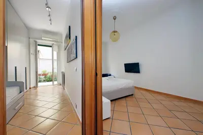 a bedroom with a bed and a bathroom at suity I cozy anglona apartment in Rome