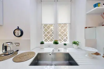a kitchen with a sink and a window at suity I cozy anglona apartment in Rome