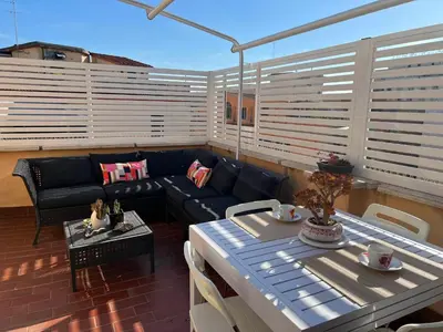 a living room with a couch and a table on a balcony at BUBUS Terrace in Rome