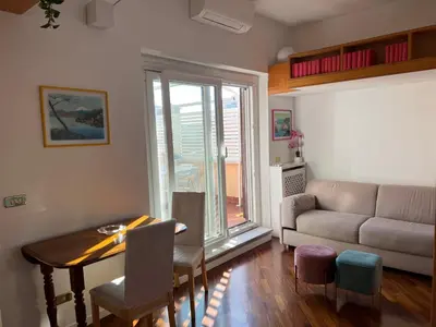 a living room with a table and a couch at BUBUS Terrace in Rome