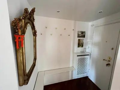 a mirror hanging on a wall next to a door at BUBUS Terrace in Rome
