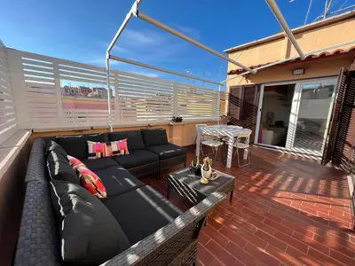 a living room with a couch and a table on a deck at BUBUS Terrace in Rome