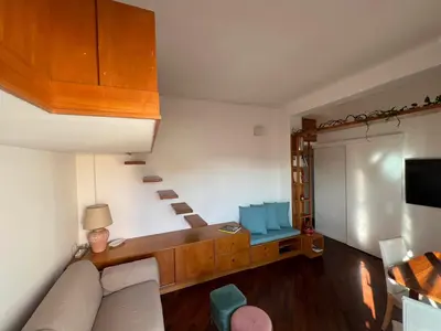 a living room with a couch and a tv at BUBUS Terrace in Rome
