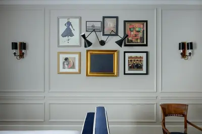 a room with a wall with pictures on it at Casa Violante Luxury Apartment in Rome