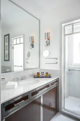 a bathroom with a large mirror and a sink at Casa Violante Luxury Apartment in Rome
