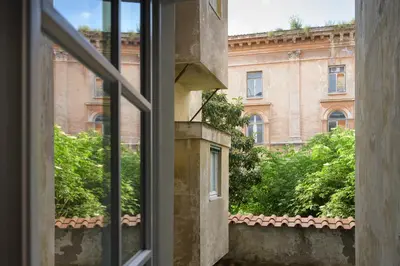 a view of a building from an open window at Casa Violante Luxury Apartment in Rome