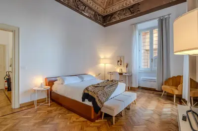a bedroom with a bed and a table and chairs at Appartamento storico in zona Barberini in Rome