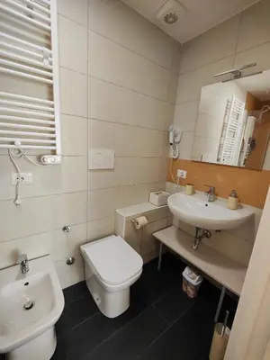 a bathroom with a white toilet and a sink at Velvet Rooms in Rome