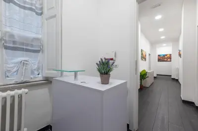 a hallway of an office with a counter with a potted plant at Velvet Rooms in Rome