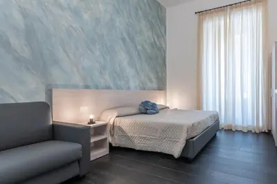 a bedroom with a bed and a couch in it at Velvet Rooms in Rome