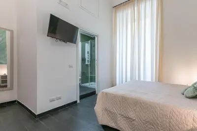 a bedroom with a bed and a flat screen tv at Velvet Rooms in Rome