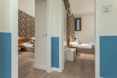 a room with a bedroom with a bed and a room with at Vittoria Garden Suites in Rome