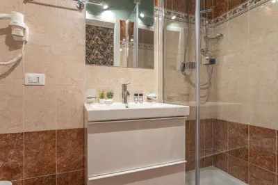 a bathroom with a sink and a shower at Vittoria Garden Suites in Rome