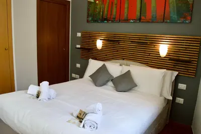 a bedroom with a white bed with towels on it at AmareRomaRooms in Rome