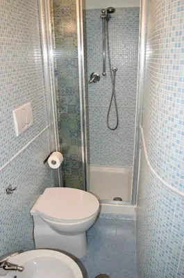 a small bathroom with a toilet and a shower at AmareRomaRooms in Rome