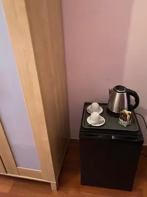 a tea kettle on top of a black table next to a door at AmareRomaRooms in Rome