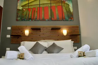 a bedroom with a white bed with two towels on it at AmareRomaRooms in Rome