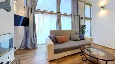 a living room with a couch and a glass table at Relais Romagnosi in Rome