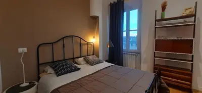 a bedroom with a bed with pillows and a window at Trastevere St Ariabianca House in Rome