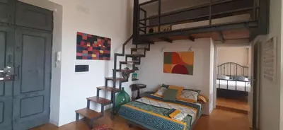 a bedroom with a bunk bed and a bed with a ladder at Trastevere St Ariabianca House in Rome