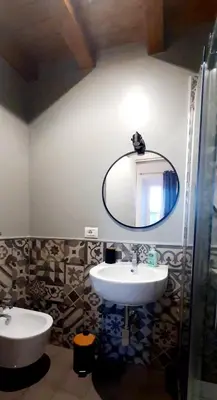 a bathroom with two sinks and a mirror at Trastevere St Ariabianca House in Rome